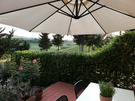 Dining outside in the small terrace with view on Vernaccia di San Gimignano famous vineyards.